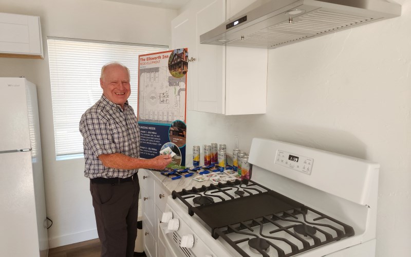 Peter Hendricks is delighted to find M&Ms offered as treats to those attending the ribbon cutting in the kitchen of the new unit.